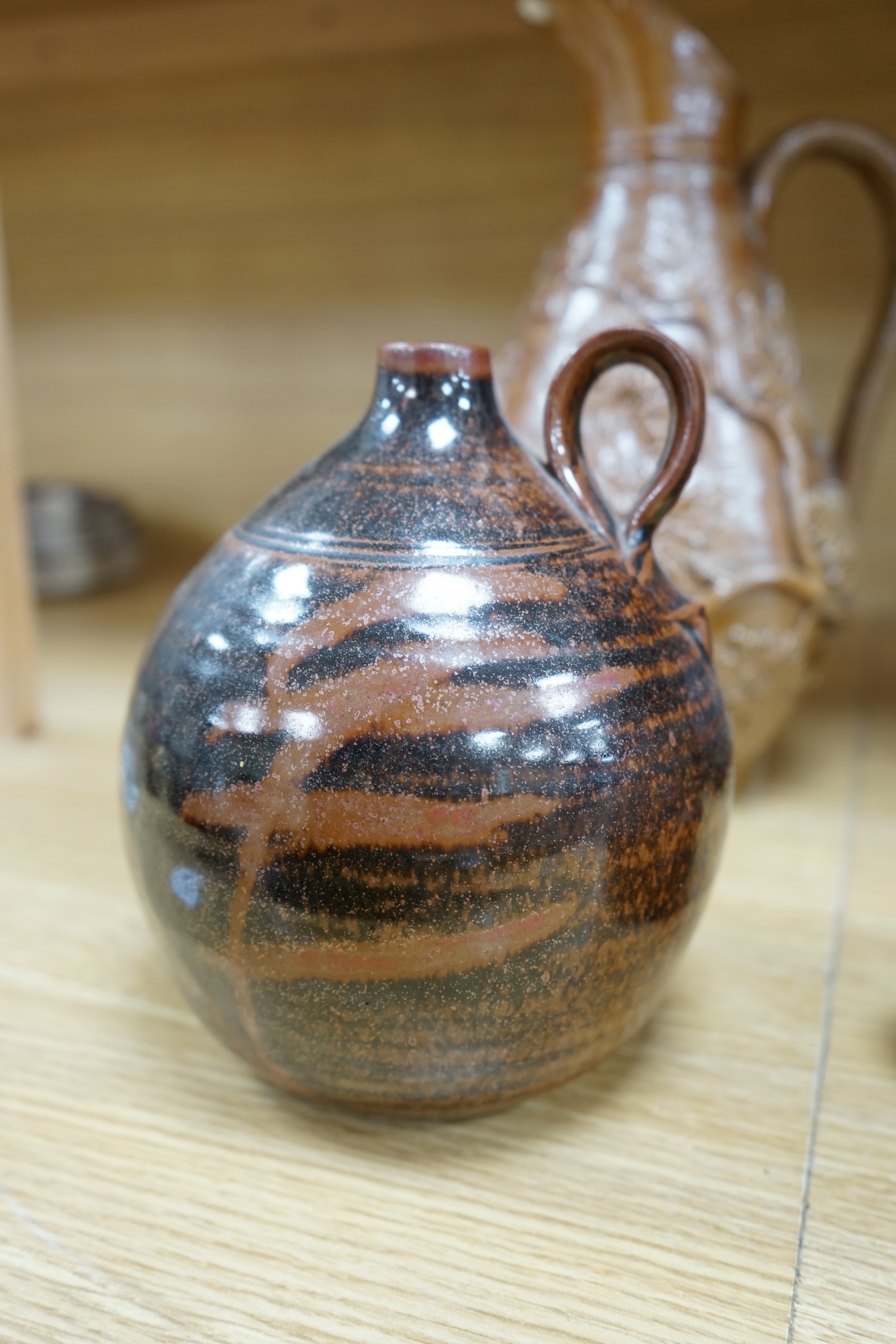 A collection of Studio pottery to include teapots and jugs, together with a pottery model of a rabbit, indistinctly signed to the base, and a French salt glazed wine jug, largest 33cm high. Condition - fair to good